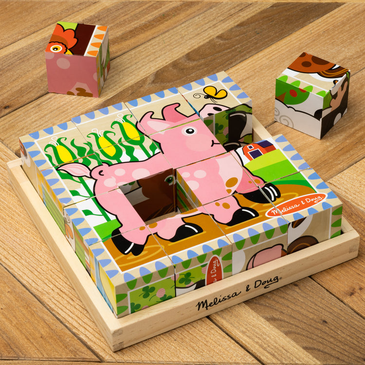 A playroom scene with The Melissa & Doug Farm Wooden Cube Puzzle With Storage Tray - 6 Puzzles in 1 (16 pcs)