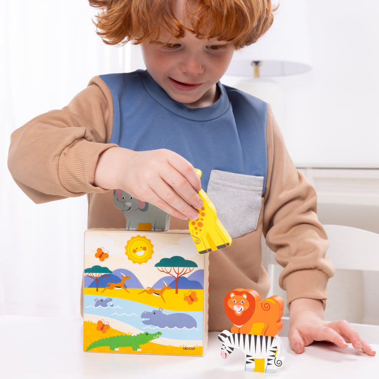 A kid playing with The Melissa & Doug Safari Animal Matching Wooden Toddler Toy Play Set Ages 2+