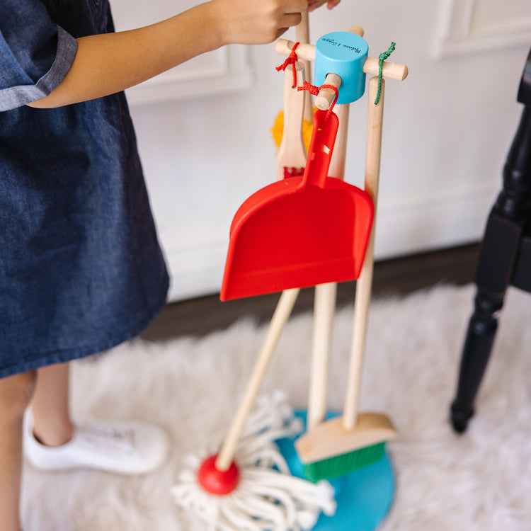 A kid playing with The Deluxe Cleaning & Laundry Play Set