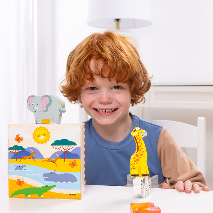 A kid playing with The Melissa & Doug Safari Animal Matching Wooden Toddler Toy Play Set Ages 2+