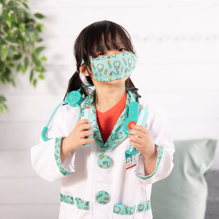 A kid playing with The Melissa & Doug Doctor Role Play Costume Dress-Up Set (8 pcs)