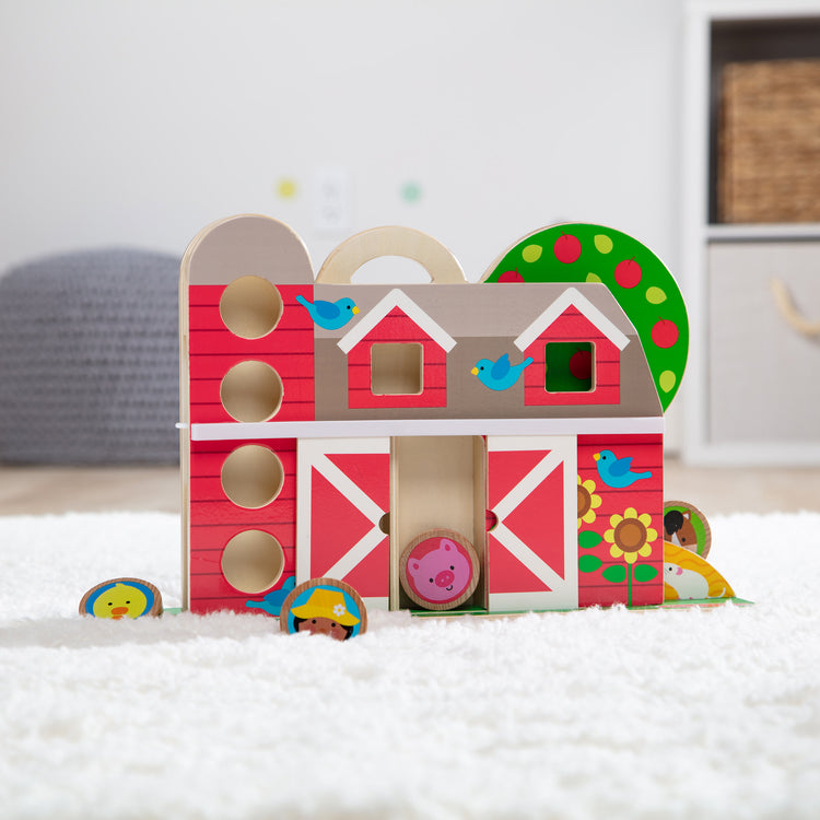 A playroom scene with The Melissa & Doug GO Tots Wooden Barnyard Tumble with 4 Disks