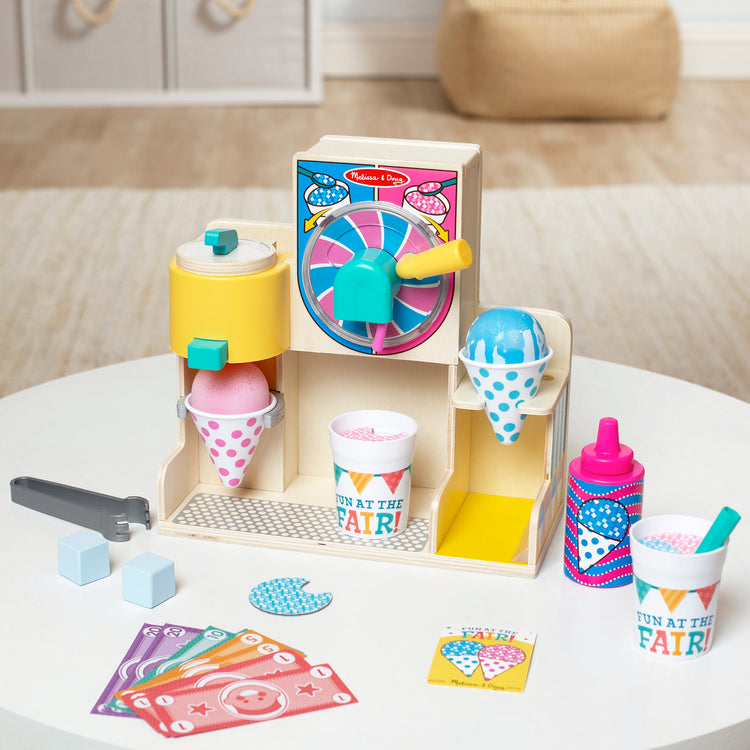 A playroom scene with The Melissa & Doug Fun at the Fair! Wooden Snow-Cone and Slushie Play Food Set