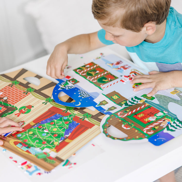 A kid playing with The Puffy Stickers Bundle - Santa's Workshop & 'Tis the Season