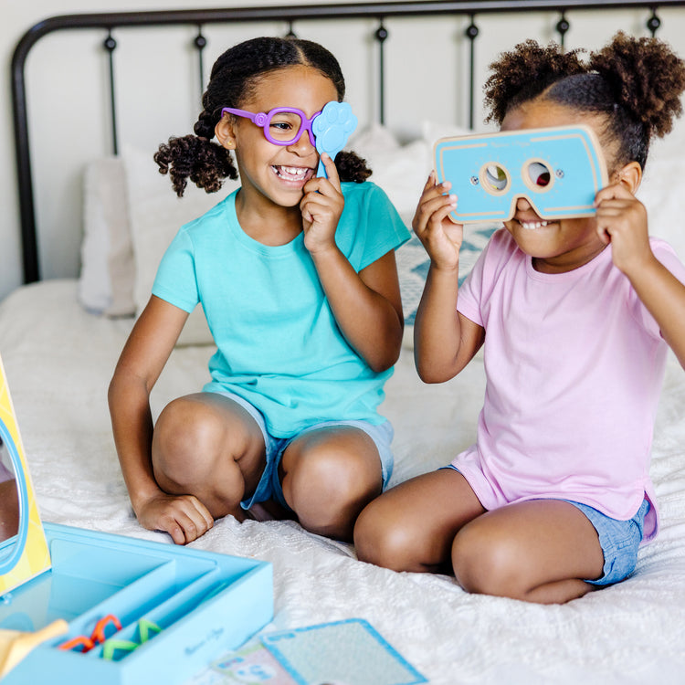A kid playing with The Melissa & Doug Blues Clues & You! Time for Glasses Play Set