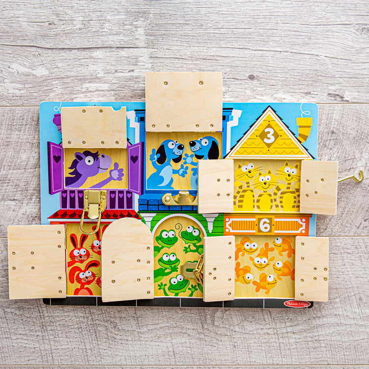 A playroom scene with The Melissa & Doug Latches Wooden Activity Board