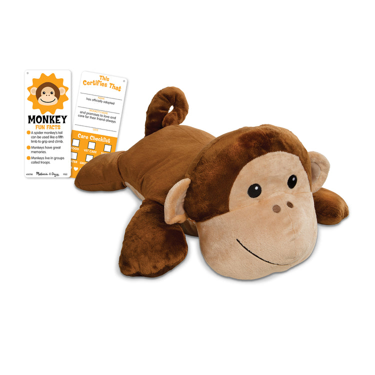 The loose pieces of The Melissa & Doug Cuddle Monkey Jumbo Plush Stuffed Animal with Activity Card