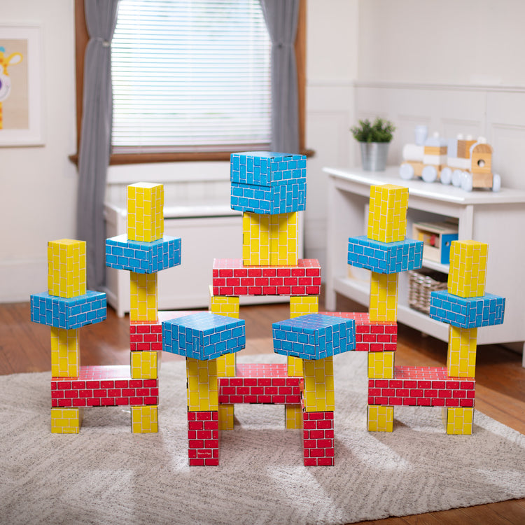 A playroom scene with The Melissa & Doug Jumbo Extra-Thick Cardboard Building Blocks - 40 Blocks in 3 Sizes
