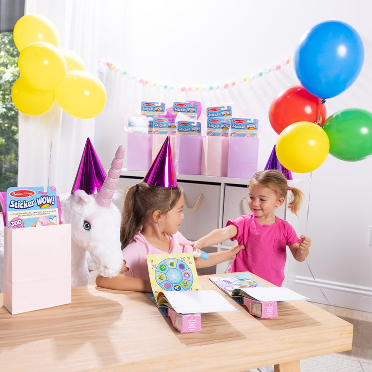 A kid playing with The Melissa & Doug Sticker WOW!™ 24-Page Activity Pad and Sticker Stamper, 300 Stickers, Arts and Crafts Fidget Toy Collectible Character – Unicorn