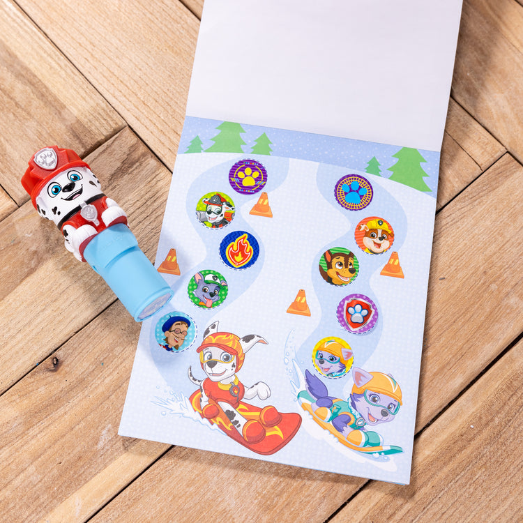 A playroom scene with The Melissa & Doug Sticker WOW!™ 24-Page Activity Pad and Sticker Stamper, 300 Stickers, Arts and Crafts Fidget Toy Collectible Character – PAW Patrol Marshall