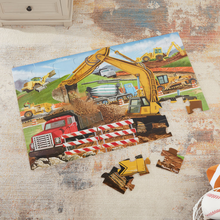 A playroom scene with The Melissa & Doug Building Site Jumbo Jigsaw Floor Puzzle - 48 pcs