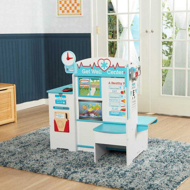 A playroom scene with The Melissa & Doug Wooden Get Well Doctor Activity Center - Waiting Room, Exam Room, Check-In Area