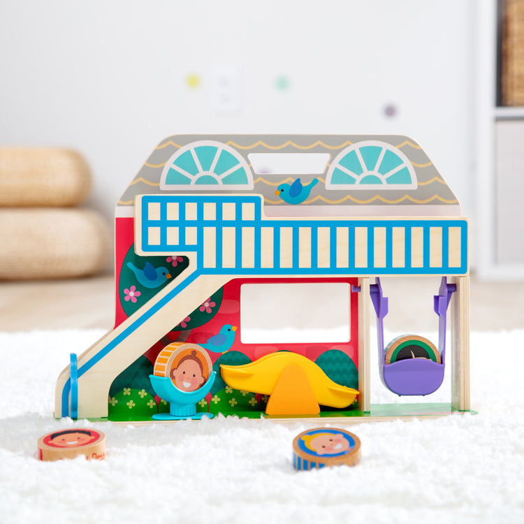 A playroom scene with The Melissa & Doug GO Tots Wooden Schoolyard Tumble with 4 Disks