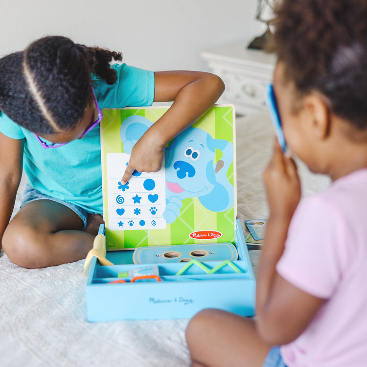 A kid playing with The Melissa & Doug Blues Clues & You! Time for Glasses Play Set