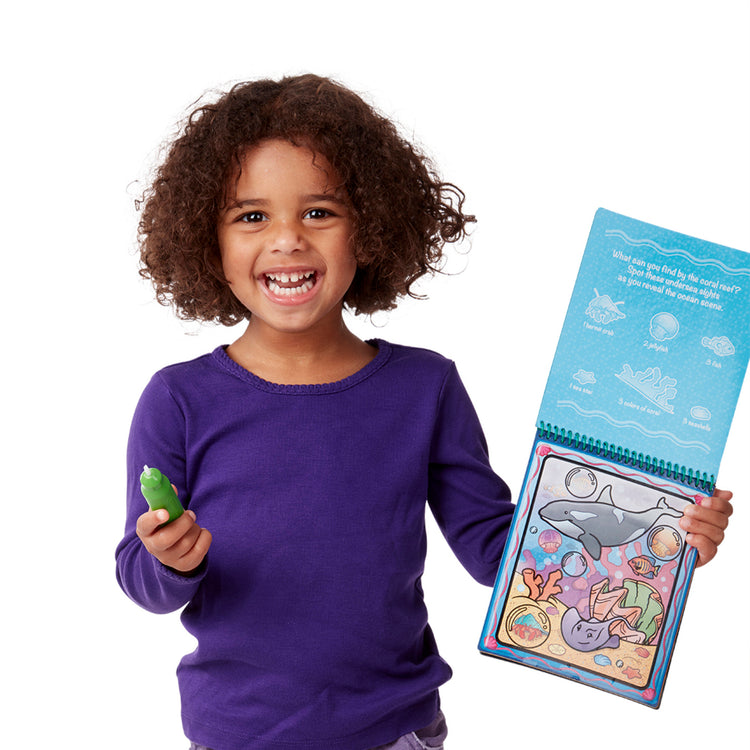 A child on white background with The Melissa & Doug On the Go Water Wow! Reusable Water-Reveal Activity Pad - Animals