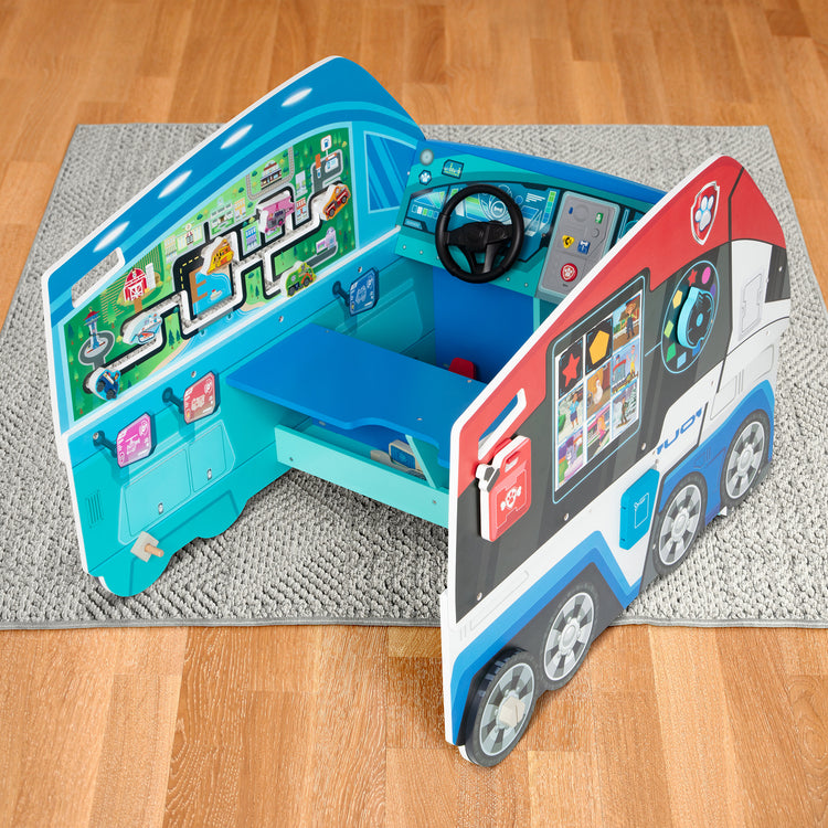 A playroom scene with The Melissa & Doug PAW Patrol Wooden PAW Patroller Activity Center Multi-Sided Play Space