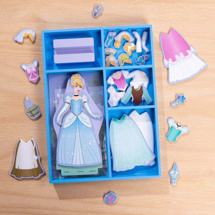A playroom scene with The Melissa & Doug Disney Princess Cinderella Magnetic Dress-Up Wooden Doll Pretend Play Set (30+ pcs)