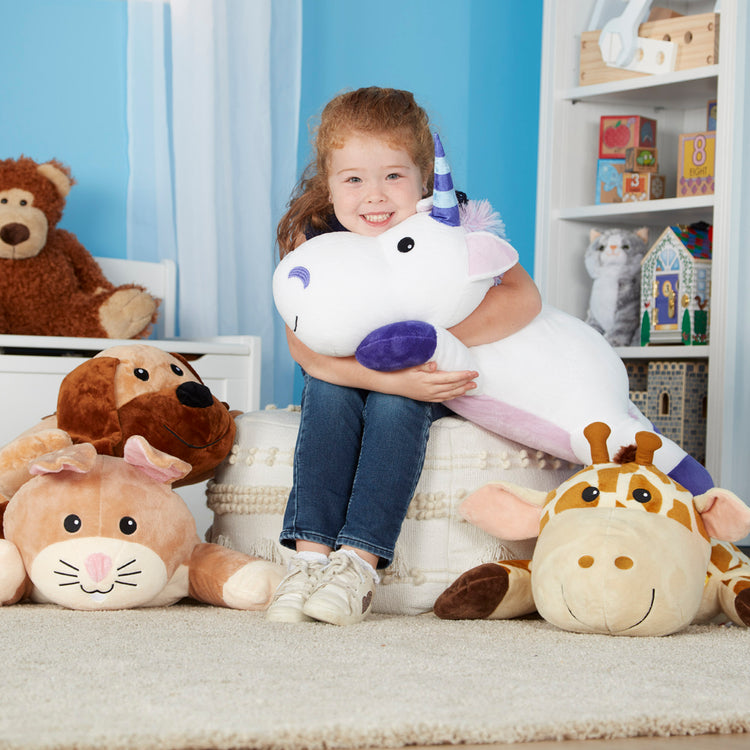 A kid playing with The Melissa & Doug Cuddle Dog Jumbo Plush Stuffed Animal with Activity Card