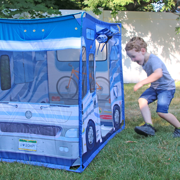 A kid playing with The Melissa & Doug Let’s Explore Camper Tent Play Set – 47” x 31” x 39” Assembled