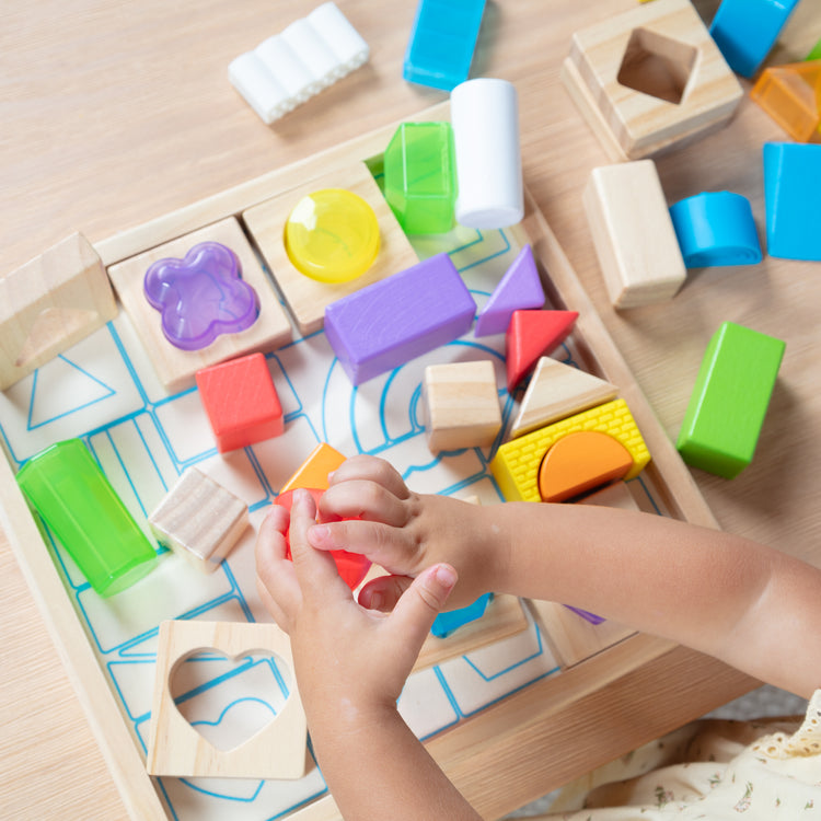 A kid playing with The Sensory Matching Blocks
