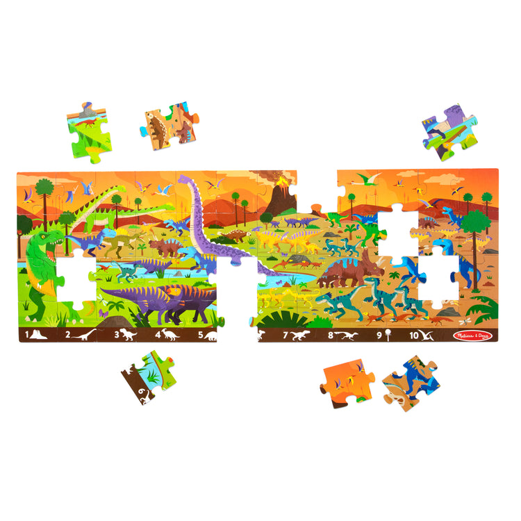 The loose pieces of The Melissa & Doug Land of Dinosaurs, Dino-Themed Search and Find Jumbo Floor Puzzle, 48-Piece Jigsaw Puzzle with Learning Activity, Over 4 Ft Long, Kids Puzzles for Girls & Boys Ages 6+