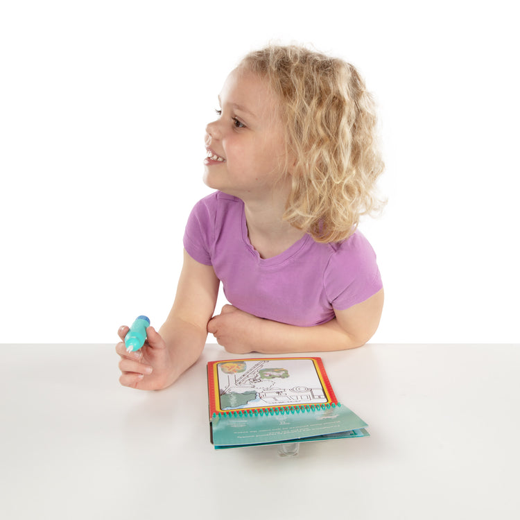 A kid playing with The Melissa & Doug On the Go Water Wow! Reusable Water-Reveal Activity Pad – Occupations