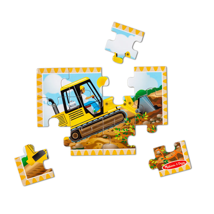 The loose pieces of The Melissa & Doug Construction Vehicles 4-in-1 Wooden Jigsaw Puzzles in a Box (48 pcs)