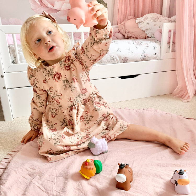 A kid playing with The Melissa & Doug Pop Blocs Farm Animals Educational Baby Toy - 10 Linkable Pieces