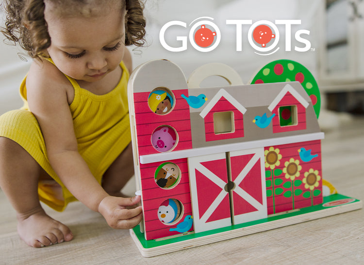 child playing with go tots barnyard toy