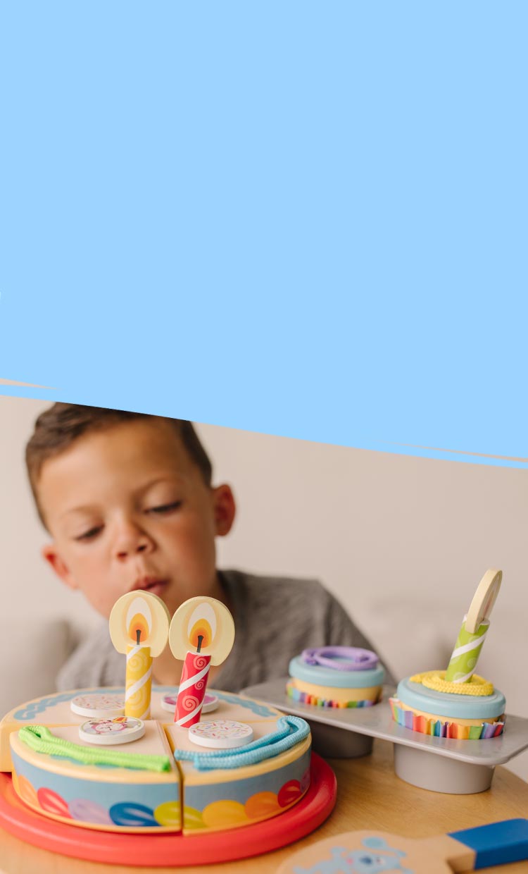 child playing with birthday cake toy