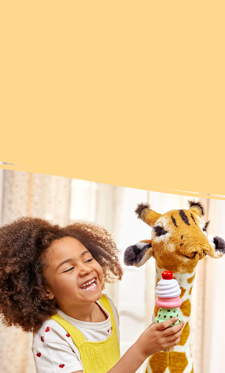 child playing with giraffe and ice cream toys