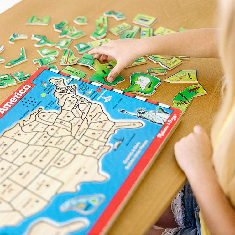 child playing with united states puzzle toy