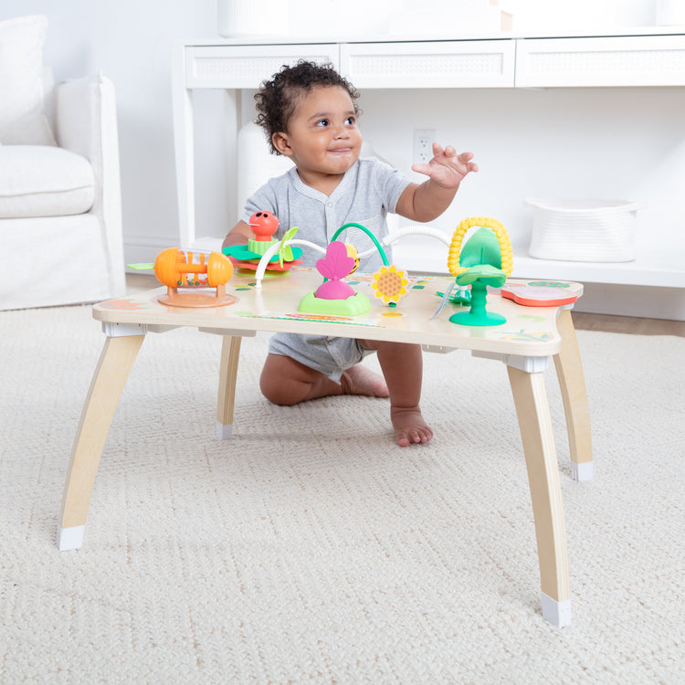 A kid playing with The Farmers Market 3 in 1 Activity Center