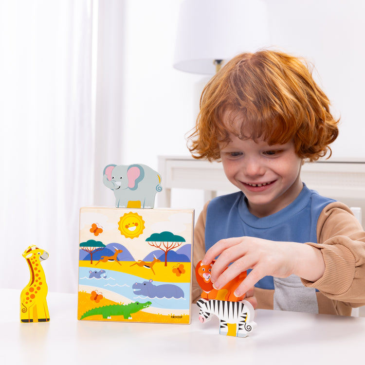 A kid playing with The Melissa & Doug Safari Animal Matching Wooden Toddler Toy Play Set Ages 2+