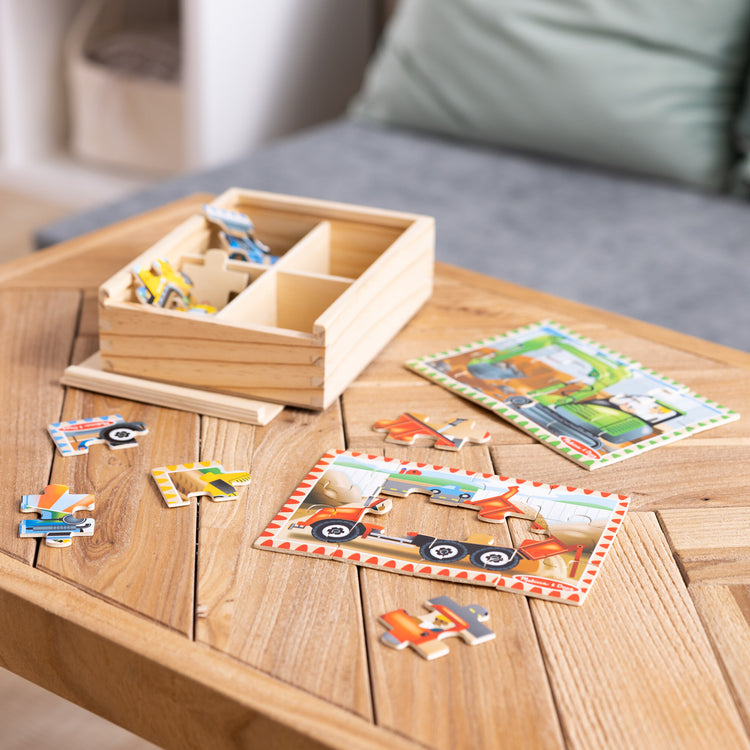 A playroom scene with The Melissa & Doug Construction Vehicles 4-in-1 Wooden Jigsaw Puzzles in a Box (48 pcs)