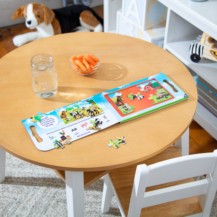 A playroom scene with The Melissa & Doug Take-Along Magnetic Jigsaw Puzzles Travel Toy On the Farm (2 15-Piece Puzzles)