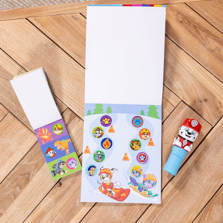 A playroom scene with The Melissa & Doug Sticker WOW!™ PAW Patrol Marshall Bundle: 24-Page Activity Pad, Sticker Stamper, 500 Stickers, Mini Pad, Arts and Crafts Fidget Toy Collectible Character