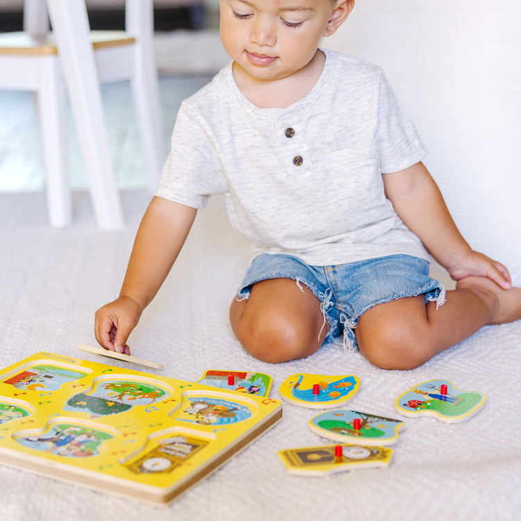 A kid playing with The Melissa & Doug Nursery Rhymes 1 Sound Puzzle - 6 PIeces