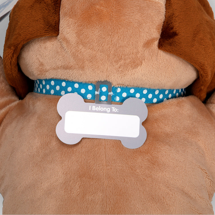 The loose pieces of The Melissa & Doug Cuddle Dog Jumbo Plush Stuffed Animal with Activity Card