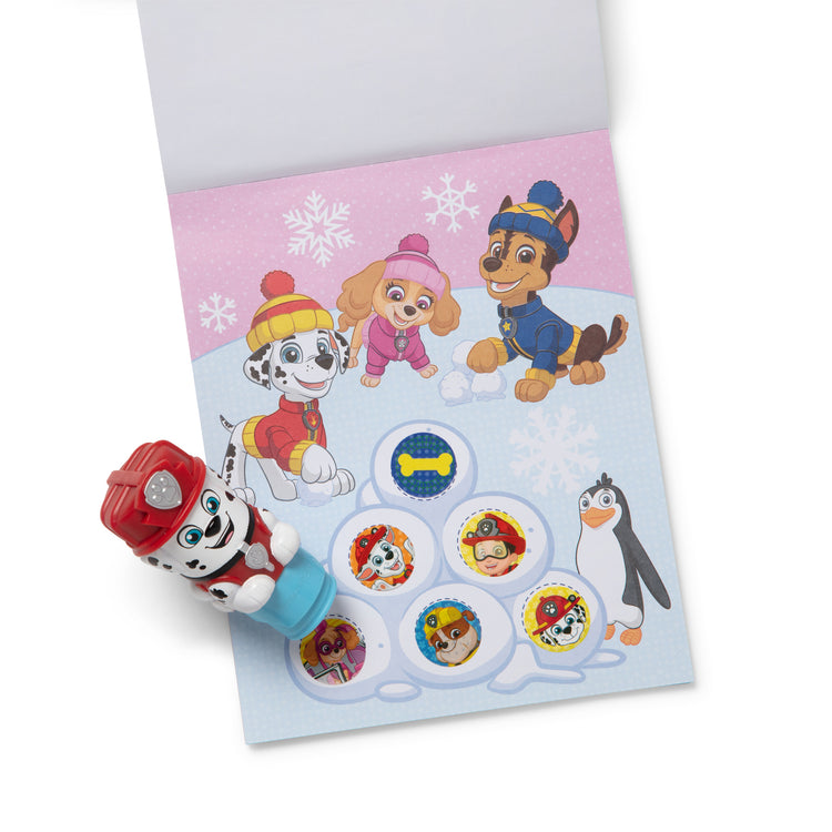 The loose pieces of The Melissa & Doug Sticker WOW!™ PAW Patrol Marshall Bundle: 24-Page Activity Pad, Sticker Stamper, 500 Stickers, Mini Pad, Arts and Crafts Fidget Toy Collectible Character