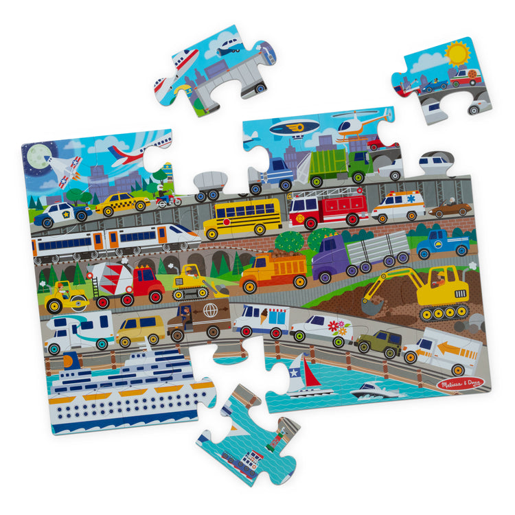 The loose pieces of The Melissa & Doug Traffic Jam, City Vehicle Themed Jumbo Floor Puzzle, 24-Piece Jigsaw Puzzle with Multiple Vehicles, 3 x 2 Foot Toddler Puzzles for Kids Ages 3+