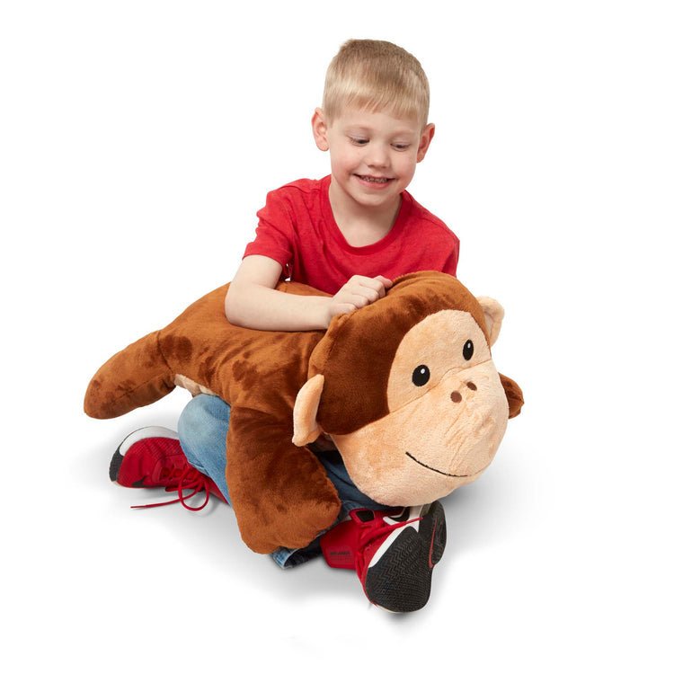 A child on white background with The Melissa & Doug Cuddle Monkey Jumbo Plush Stuffed Animal with Activity Card