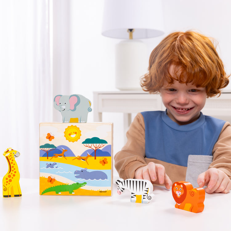 A kid playing with The Melissa & Doug Safari Animal Matching Wooden Toddler Toy Play Set Ages 2+