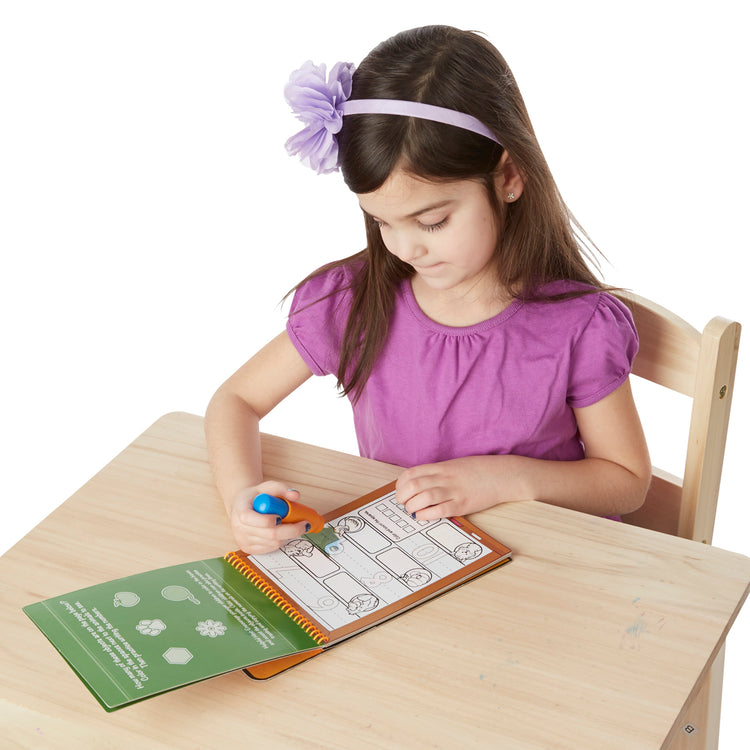 A child on white background with The Melissa & Doug On the Go Water Wow! Reusable Water-Reveal Activity Pad - Numbers