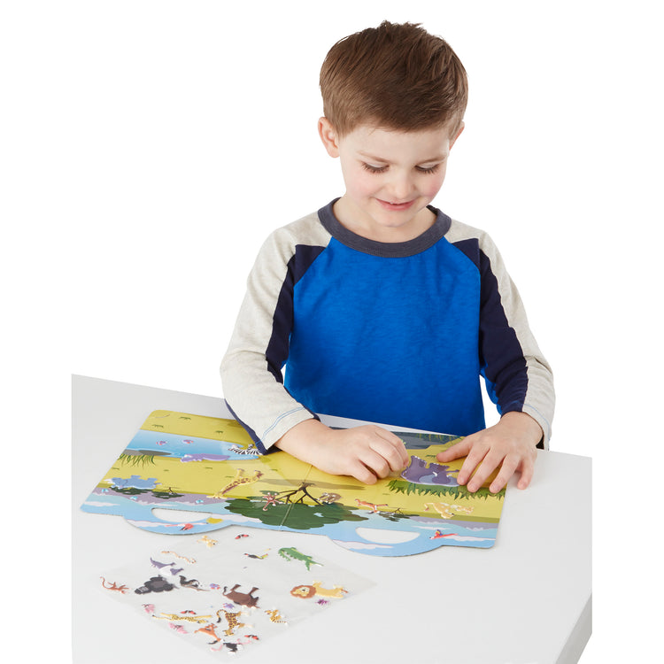 A child on white background with The Melissa & Doug Puffy Sticker Play Set: Safari - 42 Reusable Stickers