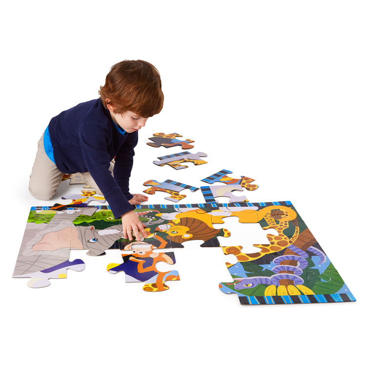 A child on white background with The Melissa & Doug Safari Social Jumbo Jigsaw Floor Puzzle (24 pcs, 2 x 3 feet)
