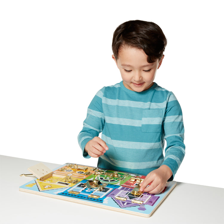 A child on white background with The Melissa & Doug Latches Wooden Activity Board