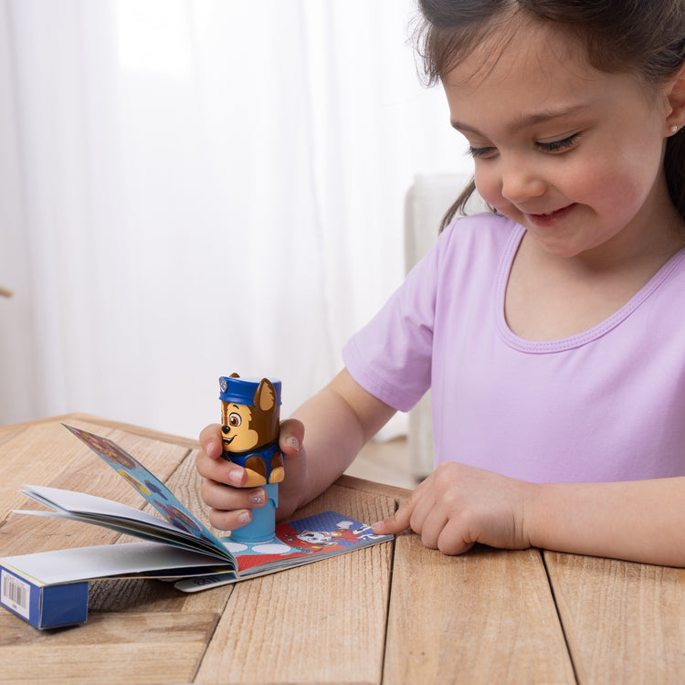A kid playing with The Melissa & Doug Sticker WOW!™ Mini Activity Pad and 200+ Refill Stickers for Sticker Stamper Arts and Crafts Fidget Toy Collectibles – PAW Patrol Stickers