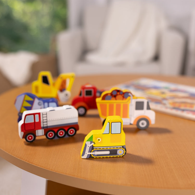 A playroom scene with The Melissa & Doug Construction Vehicles Wooden Chunky Puzzle (6 pcs)