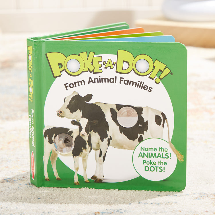 A playroom scene with The Melissa & Doug Children’s Book – Poke-a-Dot: Farm Animal Families (Board Book with Buttons to Pop)